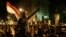 Egyptian protesters chant anti Muslim Brotherhood and Egyptian President Mohammed Morsi slogans outside the presidential palace after they broke a barbed wire barricade keeping them from getting closer to the presidential palace, in Cairo, Dec. 7, 2012.