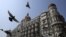 Pigeons fly outside the Taj Mahal Hotel, which was one of the targets of the attacks in Mumbai, Nov. 21, 2012.