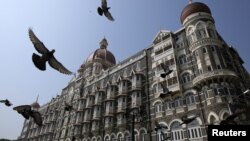 Pigeons fly outside the Taj Mahal Hotel, which was one of the targets of the attacks in Mumbai, Nov. 21, 2012.