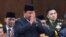 FILE - Indonesian Defense Minister and president-elect Prabowo Subianto salutes as he attends the annual lawmakers assembly to listen to President Joko Widodo's State of the Nation Address at the parliament building in Jakarta, Indonesia, Aug. 16, 2024. 