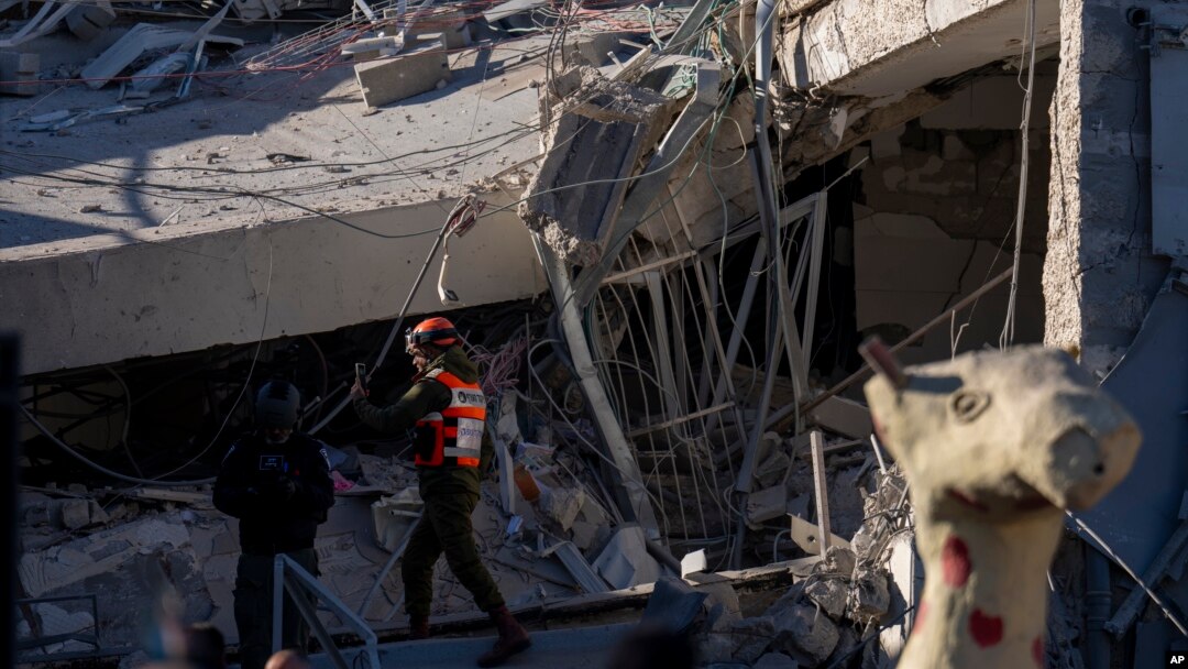 An officer from the home front command military unit examines damage after shrapnel from a Houthi missile collapsed a school building in Ramat Gan, a suburb of Tel Aviv, Israel, Dec. 19, 2024. 