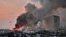A helicopter puts out a fire at the scene of an explosion at the port of Lebanon's capital Beirut, Aug. 4, 2020. 