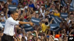 President Barack Obama greets the crowd after arriving for a campaign stop at Loudoun County High School in Leesburg, Virginia, Aug. 2, 2012. 