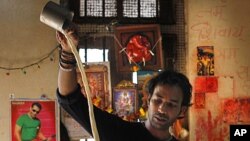 A local tea vendor makes coffee at his shop in Mumbai, India. Starbucks will open its first outlet in India by September through a 50-50 joint venture with Tata Global Beverages.