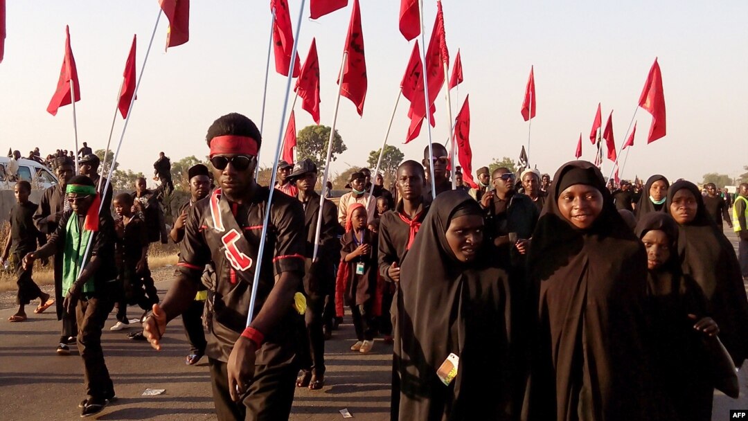 Shi'ite Muslims march during the 40th anniversary of the Ashura religious ceremony in the village of Dakasoye, northern Nigeria, following a suicide bombing attack that killed at least 21 people near Kano, Nov, 27, 2015.