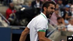 Marin Cilic, of Croatia, reacts to after a shot against Kei Nishikori, of Japan, during the championship of the 2014 U.S. Open tennis tournament, Monday, Sept. 8, 2014.