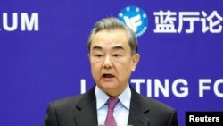 FILE - Chinese Foreign Minister Wang Yi delivers a speech in Beijing, China, Feb. 22, 2021. 