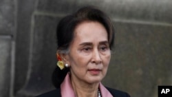 FILE - Myanmar's Aung San Suu Kyi leaves the International Criminal Court after the first of three days of hearings in The Hague, the Netherlands, Dec. 10, 2019. 