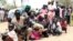 Residents displaced due to the recent fighting between government and rebel forces in the Upper Nile capital Malakal wait at a World Food Program (WFP) outpost where thousands have taken shelter in Kuernyang Payam, South Sudan, May 2, 2015. 
