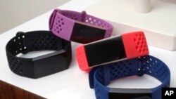 FILE - Fitbit Charge 3 fitness trackers with sport bands are displayed in New York, Aug. 16, 2018. 