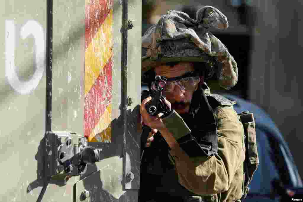 An Israeli soldier holds a rifle near a hospital in Tubas, in the Israeli-occupied West Bank.