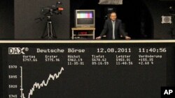 A man stands at the balcony above the DAX index board at Frankfurt's stock exchange, August 12, 2011