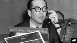 Willis Conover, an expert on jazz, broadcasts from his Voice of America studio in Washington in March 1959. (AP Photo)