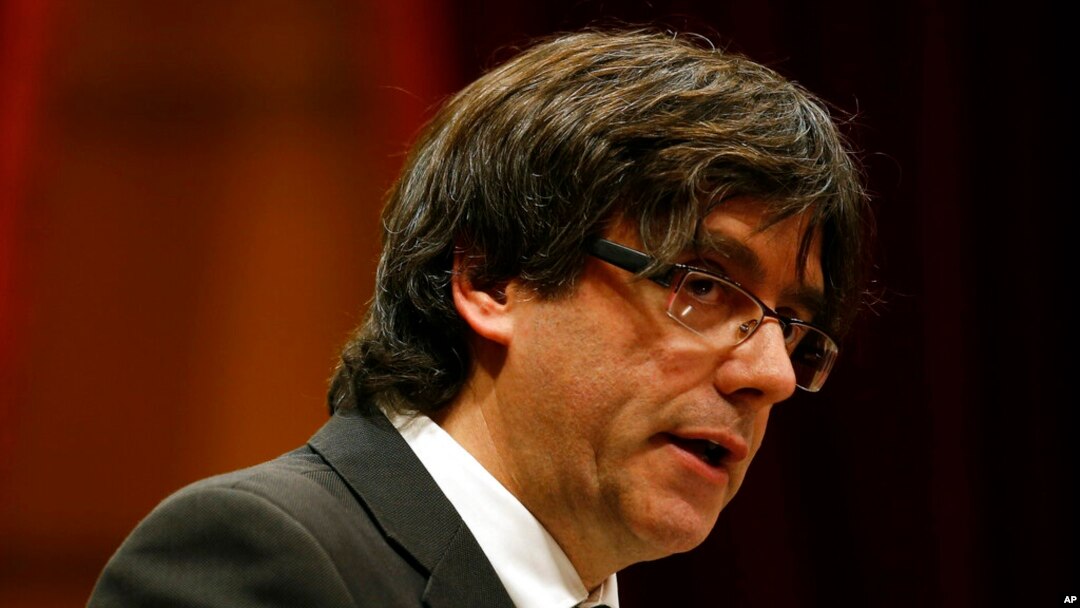 FILE - Incoming Catalan President Carles Puigdemont speaks during the investiture session at the Catalonian parliament in Barcelona, Spain, Jan. 10, 2016.