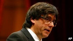 FILE - Incoming Catalan President Carles Puigdemont speaks during the investiture session at the Catalonian parliament in Barcelona, Spain, Jan. 10, 2016.