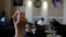 FILE - A woman holds a cigarette in a cafe in Vienna, Austria.