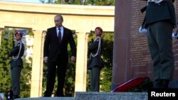 Russian President Vladimir Putin leaves after laying a wreath at the Red Army memorial in Vienna, June 24, 2014.