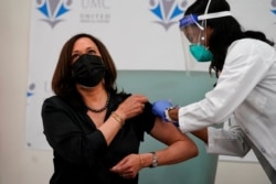 Vice President-elect Kamala Harris receives the Moderna COVID-19 vaccine from nurse Patricia Cummings, at United Medical Center in southeast Washington, Dec. 29, 2020.