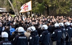 FILE - Police guard the parliament building in Podgorica, Montenegro, Dec. 26, 2019, during a protest against a then-proposed law regarding religious communities and property.