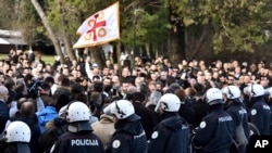 Police officers guard the parliament building in Podgorica, Montenegro, Dec. 26, 2019, during a protest against a proposed law regarding religious communities and property. 