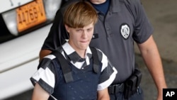 FILE - Charleston, S.C., shooting suspect Dylann Storm Roof is escorted from the Cleveland County Courthouse in Shelby, N.C., June 18, 2015.