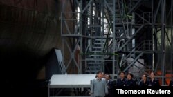 North Korean leader Kim Jong Un visits a submarine factory in an undisclosed location, North Korea, in this undated picture released by North Korea's Central News Agency (KCNA) on July 23, 2019.