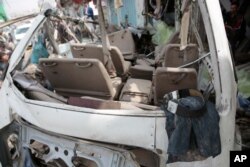FILE - The clothes of a victim lie in the wreckage of a bus carrying civilians, many of them school children, at the site of a deadly Saudi-led coalition airstrike, Saada, Yemen, Aug. 12, 2018.