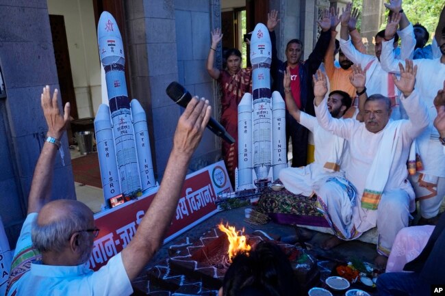 Members of India's Bharatiya Janata Party (BJP) perform Hindu rituals for the success of Indian spacecraft Chandrayaan-3, the word for "moon craft" in Sanskrit, inside a temple in Mumbai, India on July 14, 2023. (AP Photo/Rajanish Kakade)