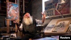 Michael Netzer, an American comics artist formerly named Mike Nasser, gestures during his interview with Reuters at his attic studio in his home in the Jewish settlement of Ofra in the Israeli-occupied West Bank