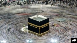 FILE - In this picture taken with slow shutter speed, Muslim pilgrims circumambulate the Kaaba, the cubic building at the Grand Mosque, durning the hajj pilgrimage in the Muslim holy city of Mecca, Saudi Arabia, Aug. 13, 2019. 