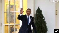 FILE - Then-President Barack Obama waves as he leaves the Oval Office of the White House in Washington, Jan. 20, 2017, before the start of presidential inaugural festivities for the incoming 45th President of the United States, Donald Trump. 