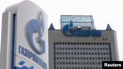 FILE - A general view shows the headquarters of Gazprom, with a board of Gazprom Neft, the oil arm of Gazprom seen in the foreground, on the day of the annual general meeting of the company's shareholders in Moscow. 