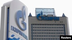 FILE - A general view shows the headquarters of Gazprom, with a board of Gazprom Neft, the oil arm of Gazprom seen in the foreground, on the day of the annual general meeting of the company's shareholders in Moscow. 