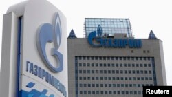 FILE - A general view shows the headquarters of Gazprom, with a board of Gazprom Neft, the oil arm of Gazprom seen in the foreground, on the day of the annual general meeting of the company's shareholders in Moscow. 