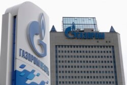 FILE - A general view shows the headquarters of Gazprom, with a board of Gazprom Neft, the oil arm of Gazprom seen in the foreground, in Moscow.