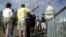 FILE -- Tourists line up outside the U.S. Capitol in Washington.