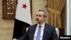 Syrian Foreign Minister Asaad al-Shaibani, looks on during an interview with Reuters in Damascus
