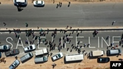FILE - A human chain is formed in a vigil calling for maintaining a U.N. resolution authorizing the passage of humanitarian aid into Syria's rebel-held northwestern province of Idlib through the Bab al-Hawa border crossing with Turkey, July 2, 2021.