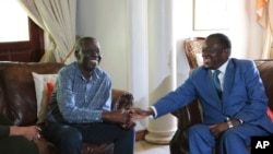 FILE - Zimbabwean President Emmerson Mnangagwa, right, talks to Morgan Tsvangirai, the main opposition leader in Zimbabwe, during a visit to his residence in Harare, Jan. 5, 2018.