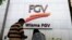 A couple talks outside FGV Holdings Berhad, one of Malaysia's largest palm oil companies, in Kuala Lumpur, Thursday, Oct. 1, 2020. Malaysian palm oil producer FGV Holdings Berhad vowed Thursday to “clear its name” after the U.S. banned imports of…