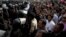 Supporters of Egyptian President Mohammed Morsi chant slogans as riot police, left, stand guard in front of the entrance of Egypt’s top court, in Cairo, Egypt, Sunday, Dec. 2, 2012.