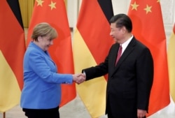 FILE PHOTO: China's President Xi Jinping meets German Chancellor Angela Merkel at the Great Hall of the People in Beijing, China, May 24, 2018.