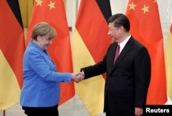 FILE PHOTO: China's President Xi Jinping meets German Chancellor Angela Merkel at the Great Hall of the People in Beijing, China, May 24, 2018.