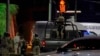 Mexican Army soldiers and a forensic expert stand guard outside the Los Cantaritos bar where an armed group broke in on the eve, killing ten people and leaving at least seven more injured, in the city of Queretaro, state of Queretaro, Nov. 10, 2024.