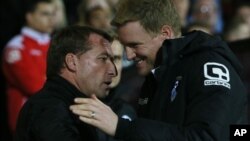 Liverpool manager Brendan Rodgers, left, and Bournemouth manager Eddie Howe speak ahead of the English League Cup soccer quarterfinal match between AFC Bournemouth and Liverpool at Goldsands Stadium, Bournemouth, Wednesday, Dec. 17, 2014. (AP Photo/Tim Ir