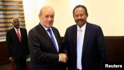 Sudan's prime minister Abdalla Hamdok shakes hands with French Foreign Minister Jean-Yves Le Drian during their meeting in Khartoum, Sudan, Sept. 16, 2019. 