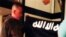 FILE - In this July 8, 2017 file image taken from FBI video and provided by the U.S. Attorney's Office in Hawaii on July 13, 2017, Army Sgt. 1st Class Ikaika Kang holds an Islamic State group flag after allegedly pledging allegiance to the terror group at a house in Honolulu. 