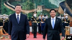 FILE - In this photo released by Xinhua News Agency, Chinese President Xi Jinping and visiting Philippine President Ferdinand Marcos Jr. appear together during a welcoming ceremony at the Great Hall of the People in Beijing, Jan. 4, 2023. 