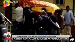 In this image taken from OBN video, the coffin of Ethiopia singer Hachalu Hundessa is carried during the funeral in Ambo, Ethiopia, Thursday July 2, 2020. More than 80 people have been killed in unrest in Ethiopia after the popular singer Hachalu…