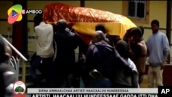 In this image taken from OBN video, the coffin of Ethiopian singer Hachalu Hundessa is carried during his funeral in Ambo, Ethiopia, July 2, 2020. 